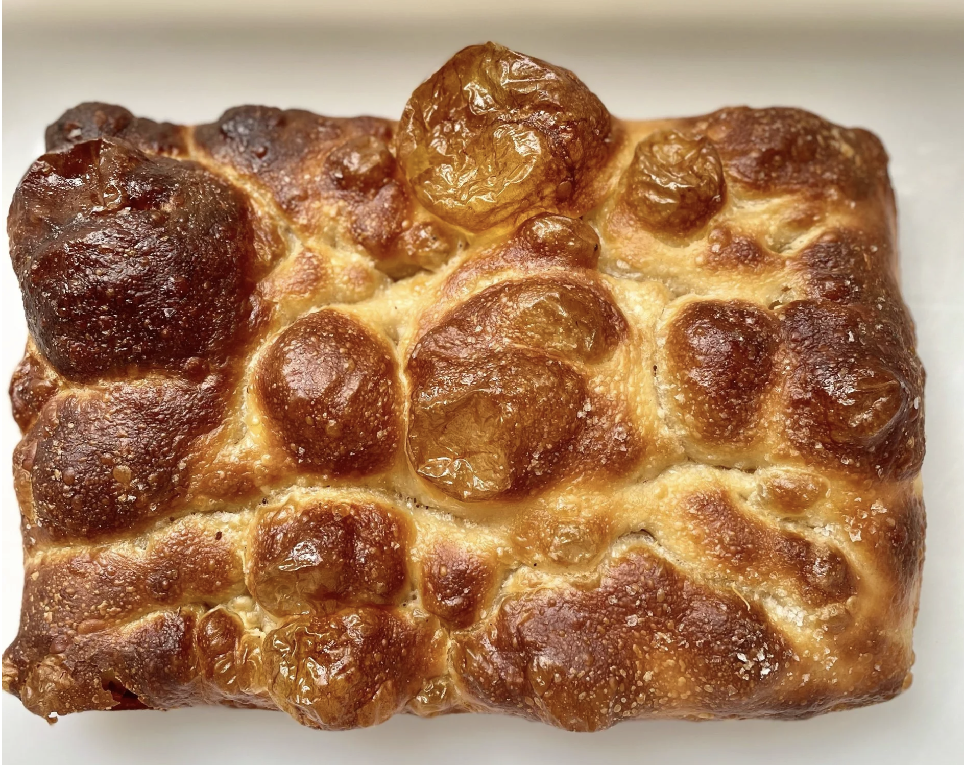 A pan of golden Billy Bread sourdough focaccia