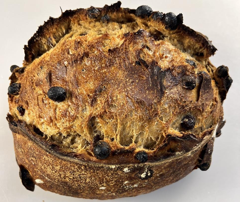 A halved loaf of Billy Bread cinnamon raisin sourdough showing raisin-studded crumb