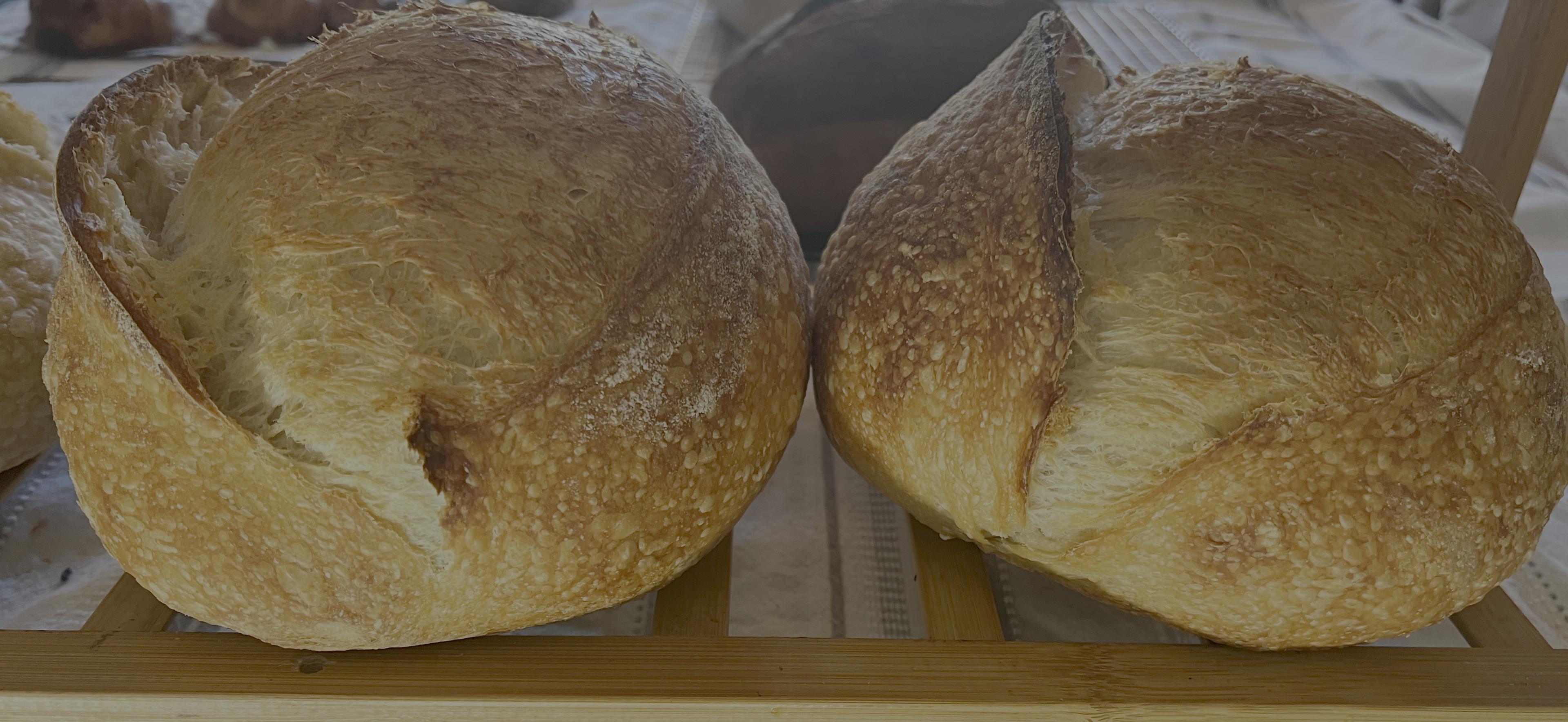 Two golden Billy Bread sourdough loaves, fresh from the oven.