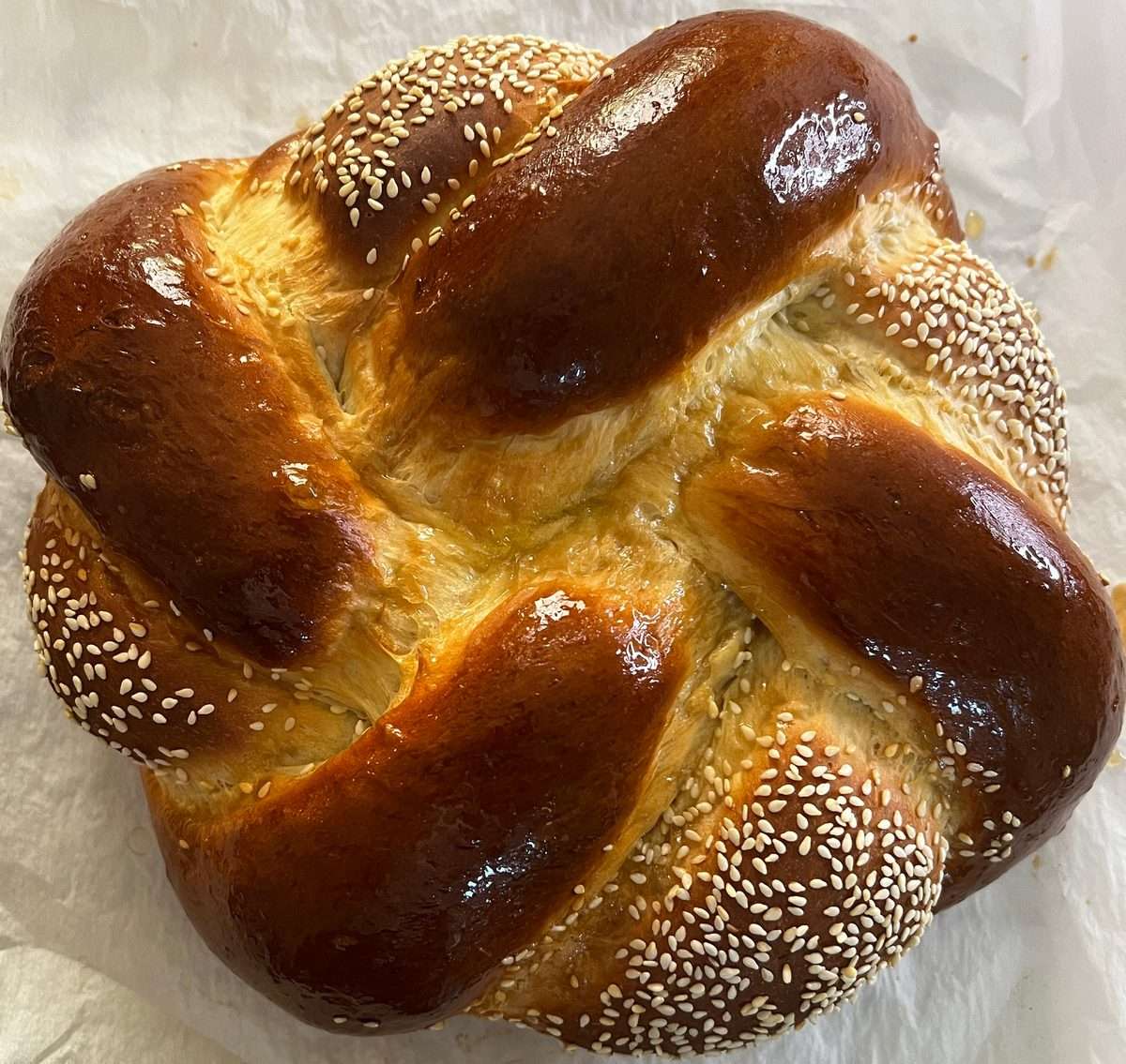 Big round braided challah with sesame seeds for Rosh Hashana